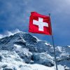 red flag on top of snow covered mountain
